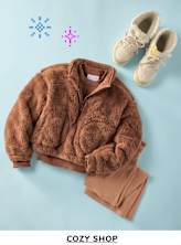 A cozy brown fuzzy jacket, a pair of beige boots, and colorful snowflake icons on a light blue background, creating a winter-themed display for a "Cozy Shop" promotion.