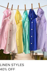 A clothesline with various pastel-colored linen shirts and coats hanging from it, against a clear blue sky background.