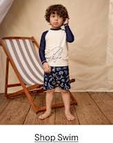 A navy blue two-piece swimsuit with a ruffled top and floral embroidered details.