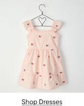 A pink dress with butterfly patterns hangs on a black wire hanger against a plain white background.