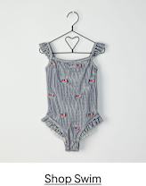 A black wire hanger with a heart-shaped top holds a striped swimsuit with small heart-shaped designs on a plain white background.