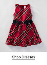 A red plaid dress with two black bows is centered against a plain white background.