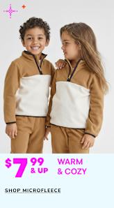 The image shows two young children, a boy and a girl, wearing matching beige outfits and smiling at each other. The background is a plain white surface, and the image is accompanied by text promoting warm and cozy microfleece clothing.