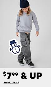 A young woman with curly hair wearing a bright green sweater and loose-fitting jeans stands against a plain white background, with a "60% off shop jeans" text overlay.