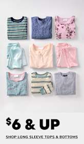 The image features two young children, a boy and a girl, wearing matching beige outfits and smiling at each other. The background is a plain white surface, drawing the focus to the warm and cozy attire of the children.