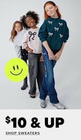 A stack of colorful, patterned sweaters with a price tag indicating a sale on soft must-have items.