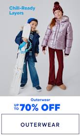 Two young children wearing warm, hooded jackets and winter boots stand in the foreground, with the text "Chill-Ready Layers" and "Outerwear up to 70% OFF" displayed in the background.