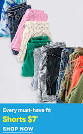 A collection of colorful shorts are neatly folded in the foreground against a white background with text overlaying the bottom.