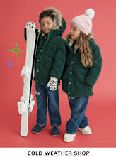 Two young children, a boy and a girl, wearing warm winter coats and holding ski equipment, stand in front of a bright red background, suggesting a cold weather shop or winter sports setting.