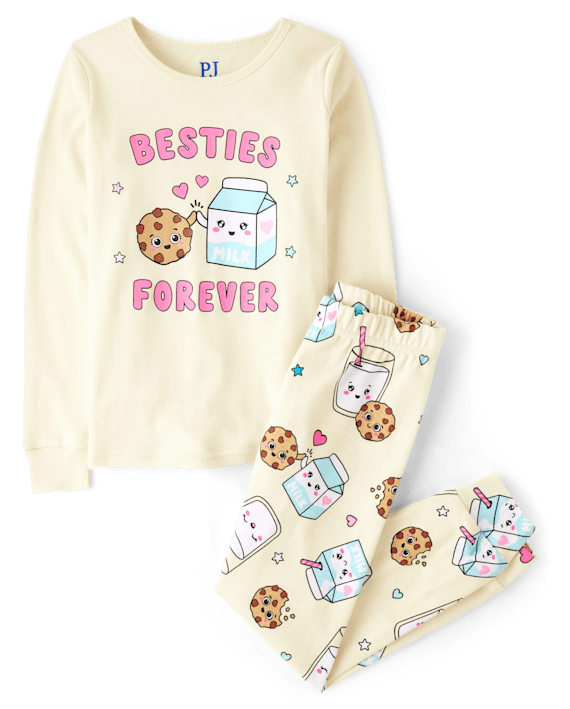 A yellow pajama top and bottom with milk and cookie cartoons on them