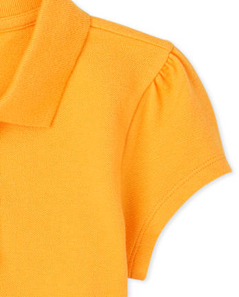 Polo de piqué con volantes de uniforme para niñas