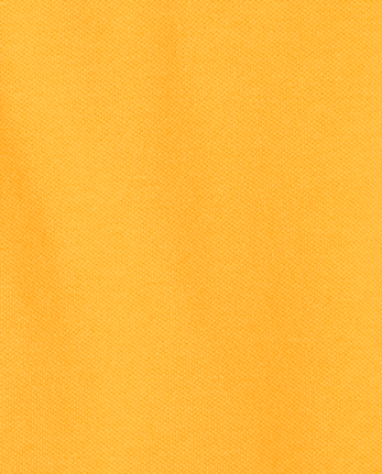 Polo de piqué con volantes de uniforme para niñas