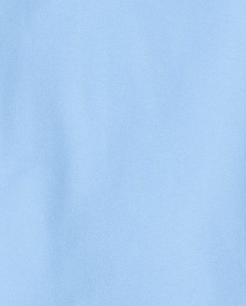 Polo de piqué con volantes de uniforme para niñas