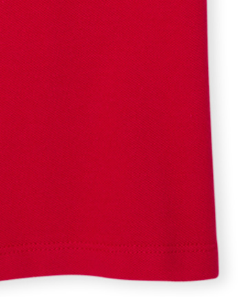 Polo de piqué con volantes de uniforme para niñas