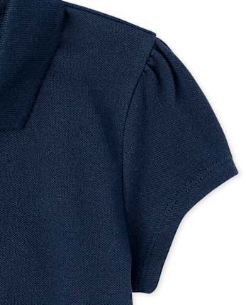 Polo de piqué con volantes de uniforme para niñas