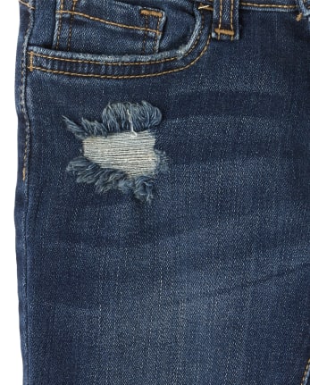 Jeans súper ajustados de mezclilla desgastada con dobladillo tulipán para niñas