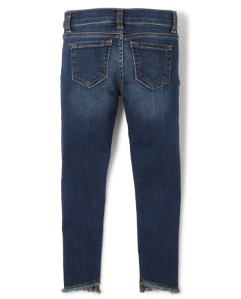Jeans súper ajustados de mezclilla desgastada con dobladillo tulipán para niñas