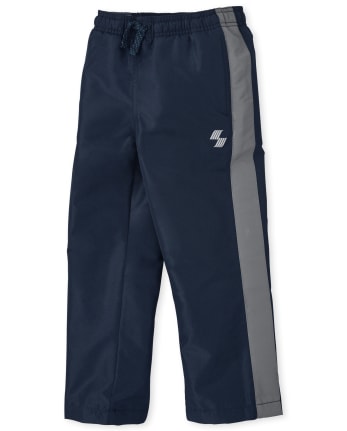 Pantalon coupe-vent à rayures latérales pour garçon