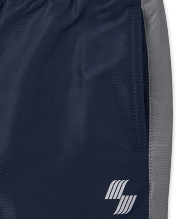 Pantalon coupe-vent à rayures latérales pour garçon