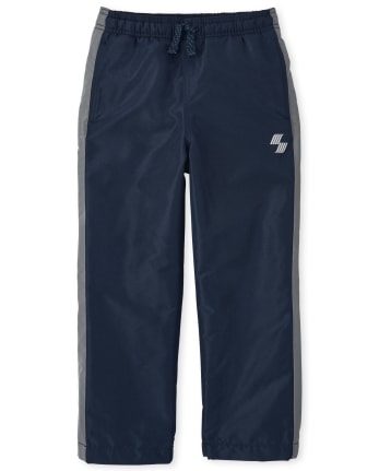 Pantalon coupe-vent à rayures latérales pour garçon