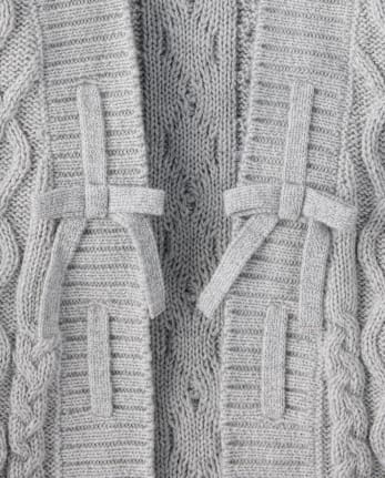 Gilet en maille torsadée à lacets et nœud pour fille