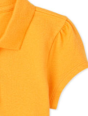 Polo de piqué con volantes de uniforme para niñas
