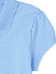 Polo de piqué con volantes de uniforme para niñas
