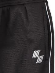 Pantalones jogger de malla con rayas laterales para niños