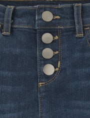 Jeans de mezclilla desgastados con botones en la parte delantera para niñas