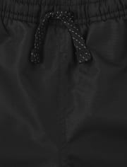 Pantalon coupe-vent à rayures latérales pour garçon