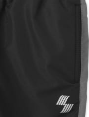 Pantalon coupe-vent à rayures latérales pour garçon