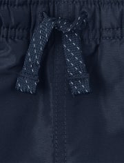 Pantalon coupe-vent à rayures latérales pour garçon