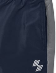 Pantalon coupe-vent à rayures latérales pour garçon