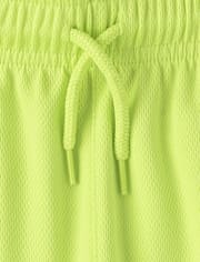 Short de sport pour enfants à séchage rapide et bandes latérales en maille