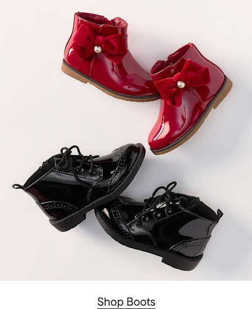 Two pairs of shiny patent leather boots, one red with bows and one black with laces, are arranged on a plain white background.