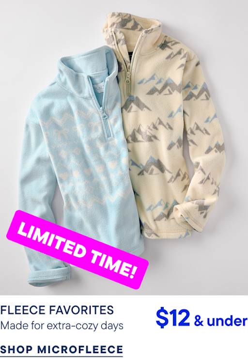 Two fleece pullovers, one light blue and one cream with a mountain pattern, lie against a plain light gray background.