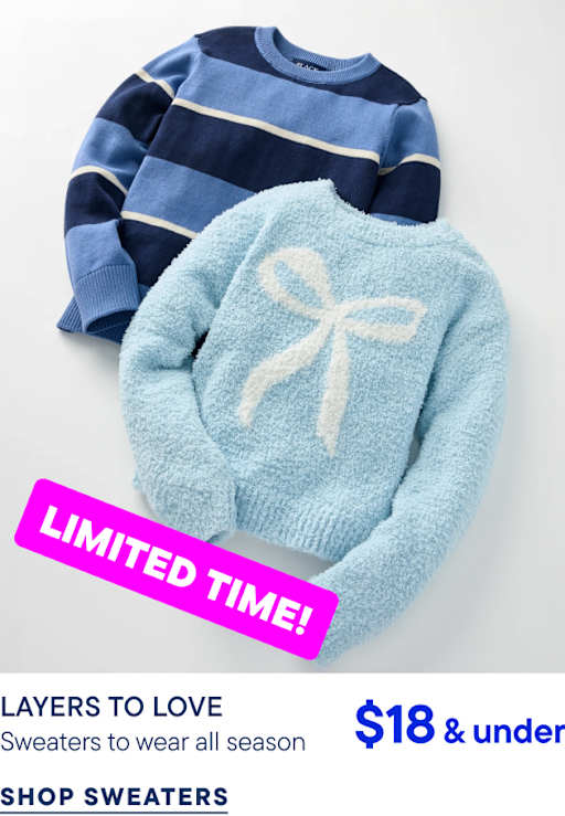 A light blue fuzzy sweater with a white bow and a navy blue striped sweater lie on a plain white background.