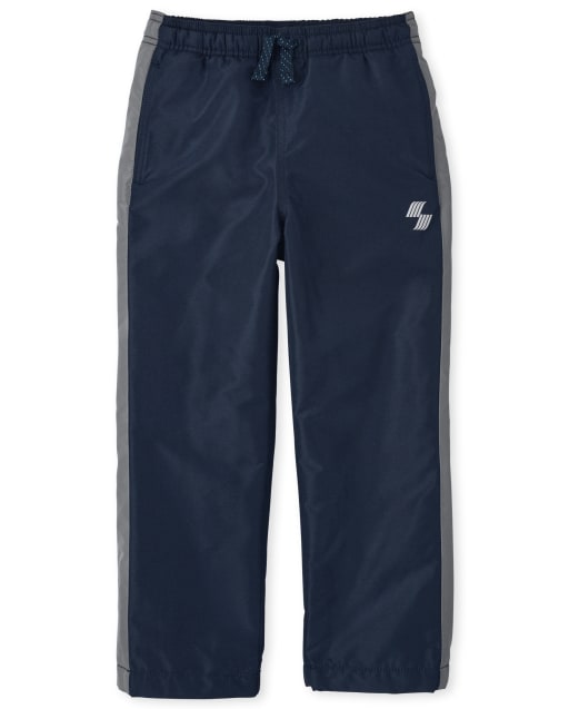 Pantalon coupe-vent à rayures latérales pour garçon