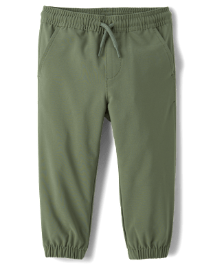 Un par de pantalones verde oliva con cordón, cinturilla elástica y tobillos con puños.