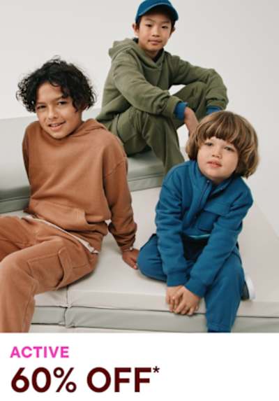 Three children, two boys and one girl, are sitting on a bench wearing casual clothing in a simple, minimalist setting.