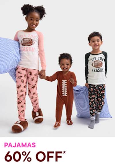 The image features three young children wearing colorful pajamas, standing together and smiling. The background is a plain white surface, drawing the focus to the children and their playful attire.