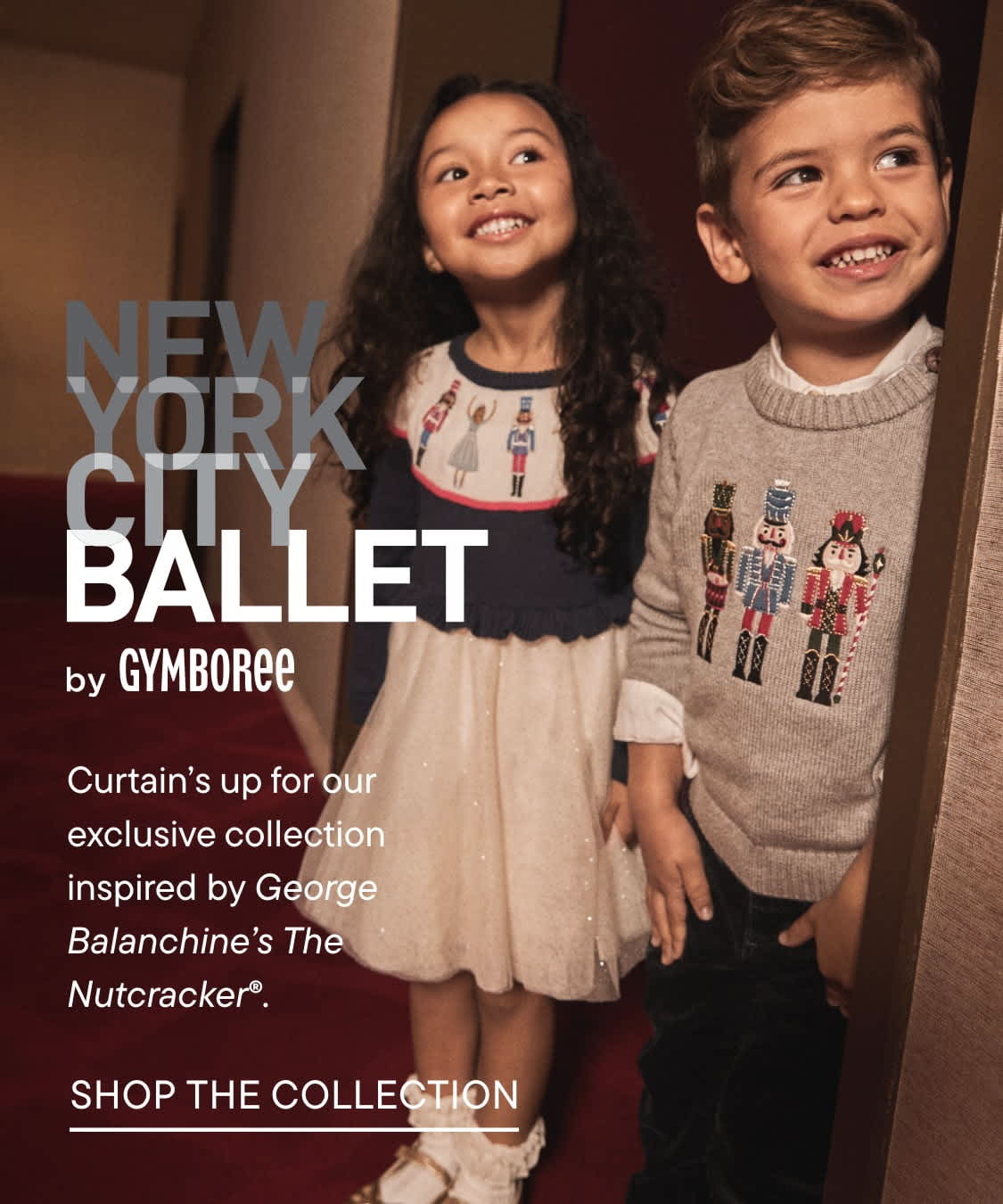 The image shows two young children, a girl and a boy, smiling and looking up at the camera. They appear to be wearing clothing with designs related to the New York City Ballet, as indicated by the text in the background.