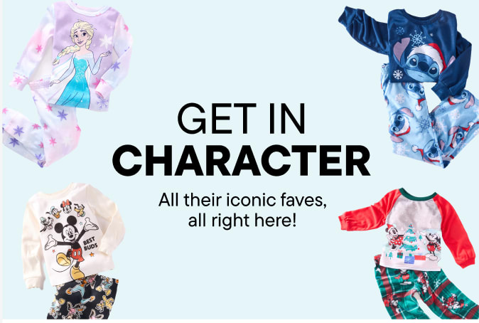 The image features a young woman with long, curly hair sitting on the floor and wearing a white graphic t-shirt, denim jacket, and jeans. The background is a plain white wall with the text "THE CHARACTER SHOP" prominently displayed.