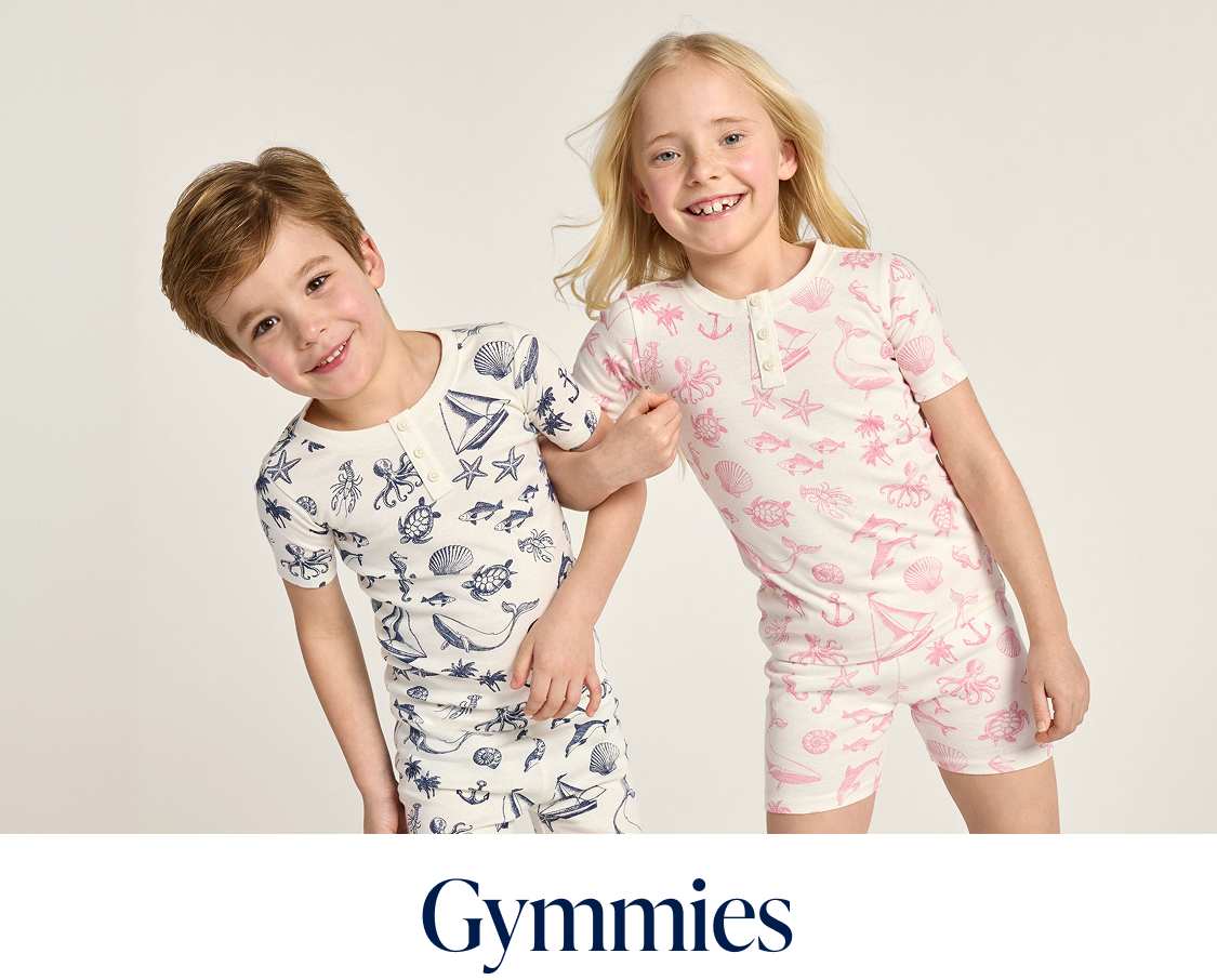 The image shows a collection of colorful and patterned pajamas, including a pink set with floral designs, a cream-colored set with animal prints, and a blue set with polka dots, all displayed against a plain background.