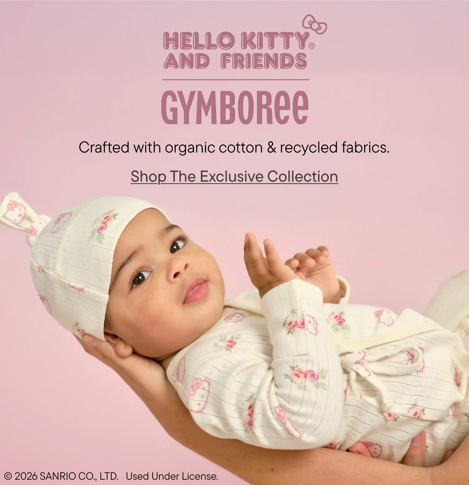 The image shows a young child wearing a white outfit with a Hello Kitty design, lying on a pink background with the "Hello Kitty and Friends Gymboree" text displayed.