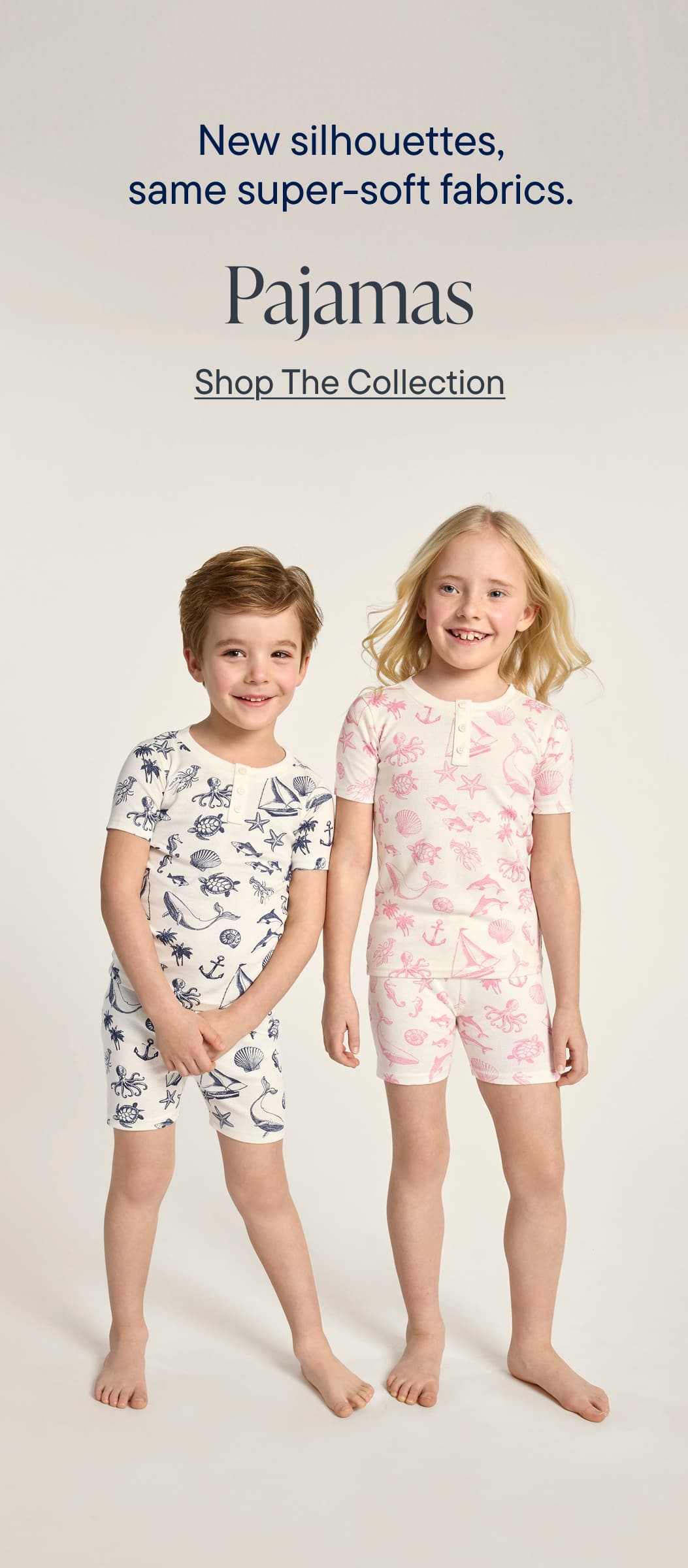 The image features two young children, a boy and a girl, wearing matching pajama sets with different patterns. The background is a plain white backdrop, highlighting the focus on the pajama designs.