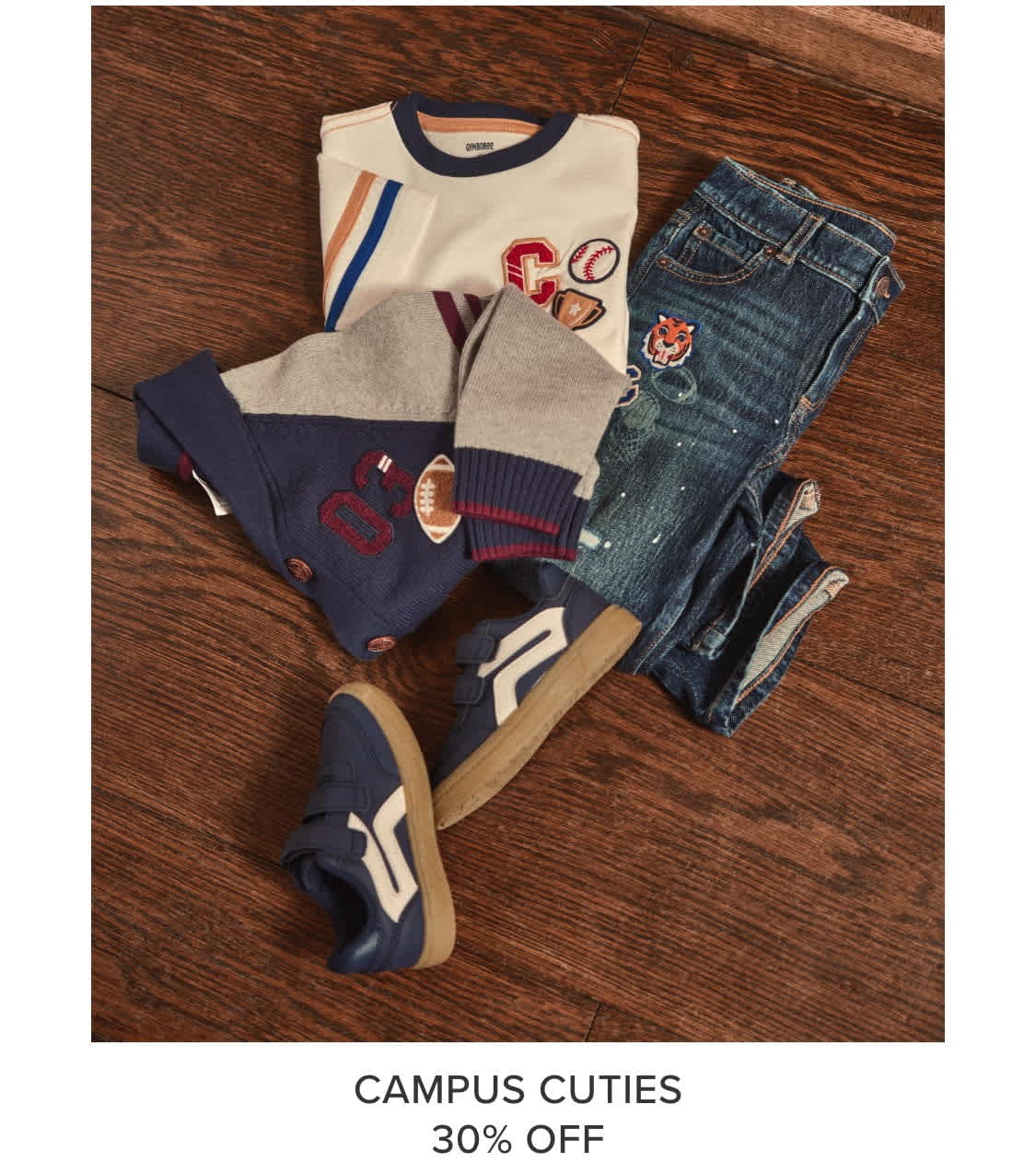 A collection of casual clothing items, including a sweater, t-shirt, and jeans, are displayed on a wooden surface, accompanied by a promotional message for a 30% discount on "Campus Cuties".