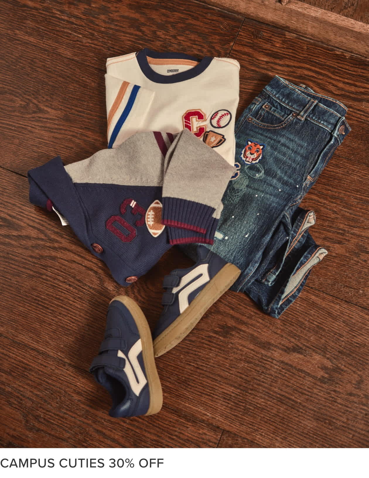 A collection of casual clothing items, including a sweater, t-shirt, and jeans, arranged on a wooden surface with a "Campus Cuties 30% OFF" text overlay.