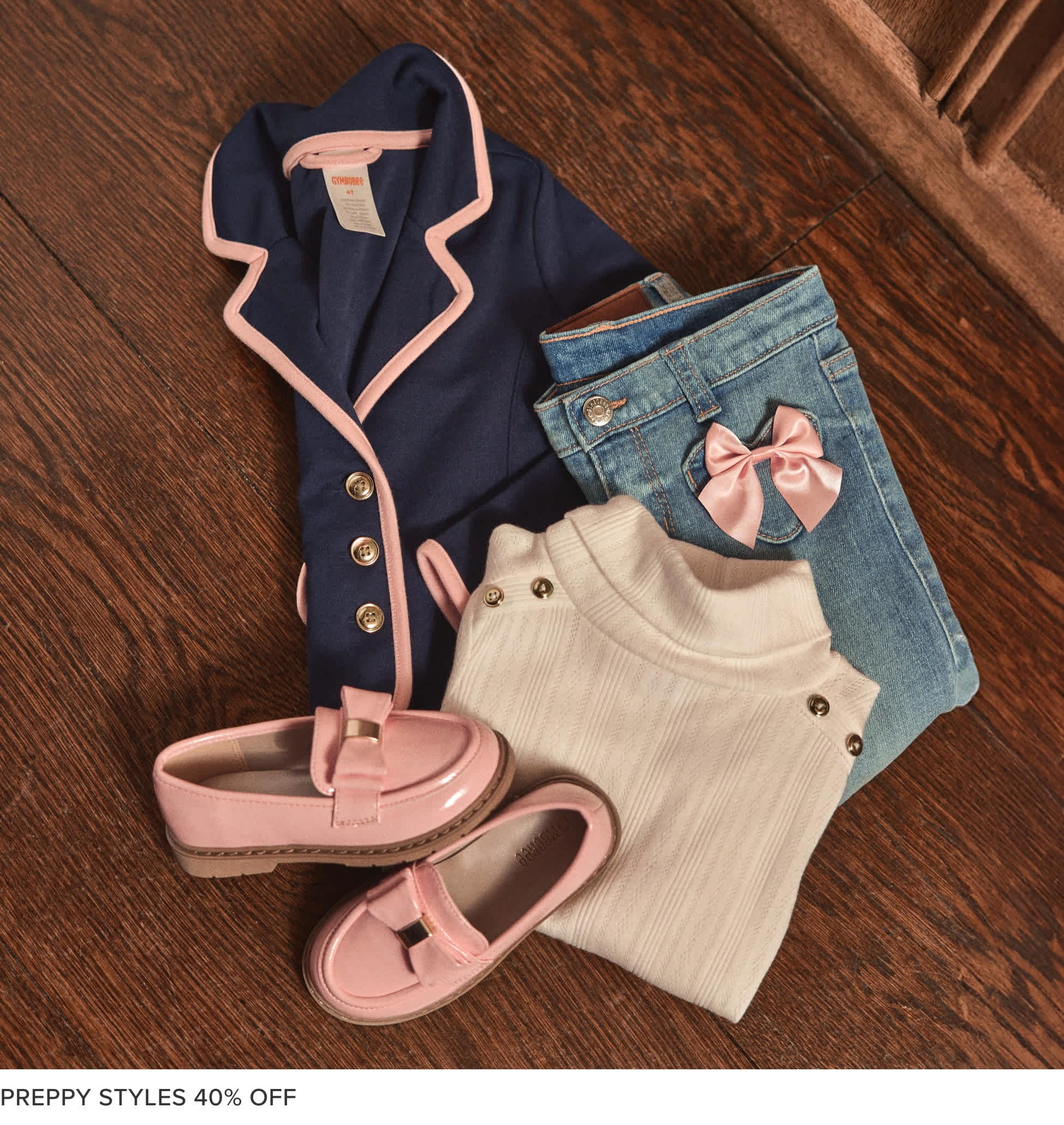 A collection of casual clothing items, including a sweater, t-shirt, and jeans, arranged on a wooden surface with a "Campus Cuties 30% OFF" text overlay.