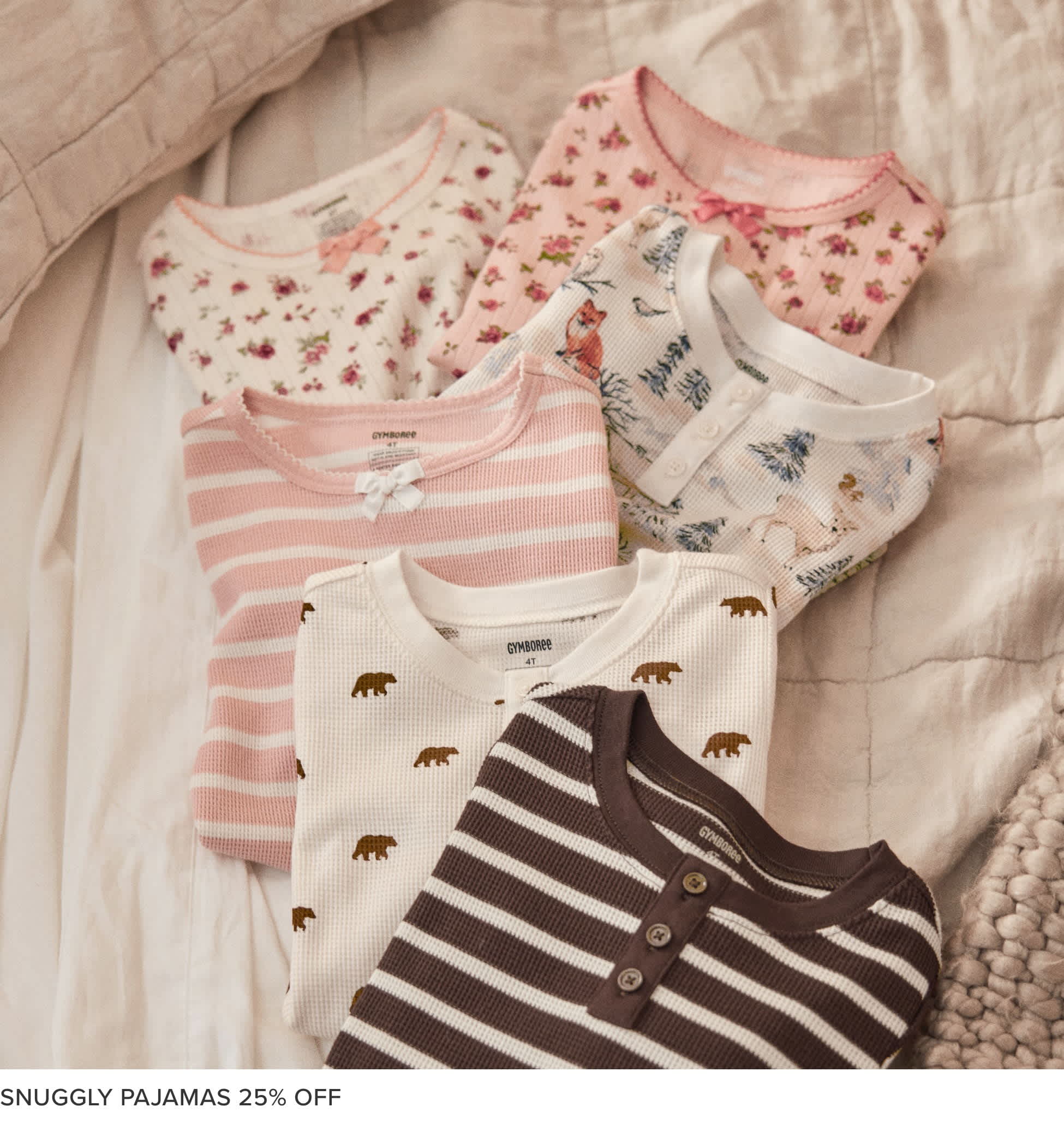 A collection of cozy, patterned pajama tops and bottoms in various shades of pink, white, and black, arranged on a soft, textured background.